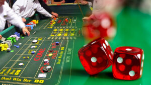 Unlike many educated gambling writers, I love gambling systems. Yes, I’m aware that they don’t change your odds of winning. That doesn’t matter. Having a systematic way to play a casino game just makes it more fun for me. I’ve even used the Martingale System, and the world didn’t end. In this post, I look at a popular craps system called “The Iron Cross.” Let’s explore how to use the Iron Cross system below. How to Use the Iron Cross Craps System The Iron Cross craps system is one of those gambling systems that covers almost every possible option on the table. You’ll rarely lose with such a system, but the size of your profits on most bets are going to be small. You’ll also eventually lose enough that the house edge will eat up your bankroll. But how do you use the Iron Cross in craps specifically? First, you place a bet on the field. This is a bet that wins if a 2, 3, 4, 9, 10, 11, or 12 gets rolled. You also make a place wager on 5, 6, and 8. The only time this combination of bets loses is if the shooter rolls a 7. When that happens, you’ll lose all the money you’ve bet. But if any other number comes up before the 7, you profit. How Does the Field Bet in Craps Work? The field bet is an example of a one-roll bet. It either wins or loses based on the next roll, and it doesn’t matter if you place the field bet on the come-out roll or on a subsequent roll. It’s also a self-service bet. You place this type of bet yourself, although the dealers still handle the payouts. The only losing numbers on a field bet are the 5, 6, 7, and 8. The casino makes a profit on this bet because the odds of hitting those other totals are relatively low. You have a limited number (16) combinations that result in a winning number. You have 20 different combinations that result in a 5, 6, 7, or 8. The payouts for the field bet depend on which number is rolled. If a 2 or 12 is rolled, you get 2 to 1 on your money. In some generous casinos, you might even get 3 to 1 when a 2 or 12 is rolled. Craps All the other numbers result in an even money payout. The field bet in craps, like almost every other bet in the casino, gives the house a mathematical edge. Most of the time, this edge is 5.56%. If you’re at a casino with the 3 to 1 payouts, the edge is only 2.78%. I should mention that the house edge for the pass line bet is significantly lower at 1.41%, by the way. How Do Place Bets Work? You can make a place bet on the numbers 4, 5, 6, 8, 9, or 10 whenever you want to. To make a place bet, you put the chips in front of you and tell the dealer you want to make a place bet on the number you choose. The place bet is NOT a self-service bet. Unlike the field, the place bet is a multi-roll bet. It stays in action until the number you placed is rolled or until the shooter rolls a 7. If the shooter rolls the place number before a 7, your bet wins. And if the shooter rolls a 7 first, the bet loses. When you win such a bet, the dealer pays you off, but he keeps your original place bet in action unless you tell him you want to take the bet down. Also, the place bets are usually turned off for the come-out roll, but you can tell the dealer you want to keep that bet working even then. A place bet pays off based on the number, as follows: Place 4 or Place 10 pays off at 9 to 5 odds Place 5 or Place 9 pays off at 7 to 5 odds Place 6 or Place 8 pays off at 7 to 6 odds The house edge varies based on the number, too. The house edge is lowest (1.52%) on the 6 or the 8, but it goes up to 4% on the 5 or 9. The biggest edge is on a 4 or 10 at 6.67%. If you’re using the Iron Cross system, you’re only making a place wager on 5, 6, and 8. The Iron Cross System Doesn’t Lower the House Edge If you’ve read much of my writing before this, you probably already realize that combining negative expectation bets never results in a positive expectation. It’s like adding negative numbers together. It doesn’t matter what size those numbers are, your eventual outcome is always negative. That doesn’t mean this system isn’t fun to play. What makes it fun? The place bets. Real money craps is a notoriously streaky game, and shooters often go on streaks where they don’t roll a 7 for a long time. When this happens, you’ll be getting even-money payouts on your field bet repeatedly, and you’ll also often be getting slightly bigger payouts on numbers (the place number bets) that stay in action and keep hitting. And you get all this action with a minimal amount of effort on your part. How to Have Even More Fun With the Iron Cross System I’ve already established that you’ll go on repeated streaks where you get a win on every roll of the dice, and the winnings will seem to pile up. Of course, a couple of 7s in a row, and you’ll see those winnings start to wash away. But you can have even more fun with the Iron Cross system by occasionally pressing your bets. In other words, when you win, you leave your winnings on the table and increase the size of your bet. You can set any kind of arbitrary limit to how many times you’ll press your bets, but 3 is a common number. The nice thing about pressing your bet and winning 3 times in a row is that you’ll win a significant amount of money. Cash Let’s look at an example: You bet $10 on the field and win. You leave the $10 on the table along with your winnings, so you’re now betting $20. You win again, and now, you have $40 in action. When and if you win your last bet, you get $80 for your trouble, which is a great return on a $10 bet. When you start pressing your bets on the place bets, you stand to see even bigger numbers because you’re getting more than even money on each bet. Some Gamblers Like to Play “With the House’s Money” Another variation of the press your bet idea is to win the field bet two or three times in a row, then you take your original bet off the table. At this point, the idea is that you’re now playing with the casino’s money. This is an interesting way to look at it. After all, you’re betting profits that you made from your time playing in the casino up to that point. But at the same time, any money you’ve won is YOUR money, not the casino’s. The house edge doesn’t care. It’s like a force of nature. It accounts for the fact that you’re playing “with the casino’s money.” An Alternative to the Iron Cross System Here’s my suggested alternative to the Iron Cross: Bet the pass line on the come-out roll. Then take maximum odds on that bet when a point gets thrown. Also, make a come bet on subsequent rolls until you have four bets working at the same time on the table. You’ll be dealing with a lower house edge, and you’ll still be seeing plenty of wins because you have so many bets in action. One thing to keep in mind with this alternative or with the Iron Cross is that you should keep your bet sizes low. It’s easy to go broke fast at the craps table when you get a lot of different bets on the table. The only way to avoid this is to keep the sizes of those bets low. Conclusion That’s basically everything you need to know to use the Iron Cross system at the craps table. Does the Iron Cross system work? If you define success as overcoming the house edge and getting one over on the casino, the answer, sadly, is no. But if your idea of success is to have fun as an action player and seeing lots of small-ish winning streaks, the Iron Cross is as good as any other craps system and better than most.